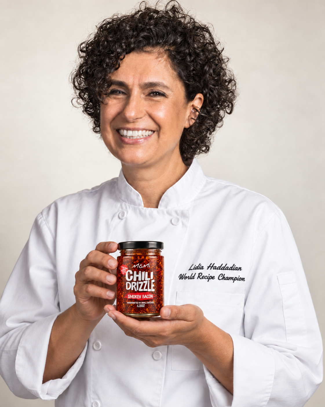 Lidia Haddadian holding a jar of MÖMI Chili Drizzle